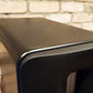 Salon 1 Audio Børresen Z3 floor standing loudspeaker in a sleek satin black finish against a rustic brick wall