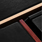 Salon 1 Audio Sonus faber Lumina speaker detail showing black leather texture, wood veneer, and layered cabinet edges.