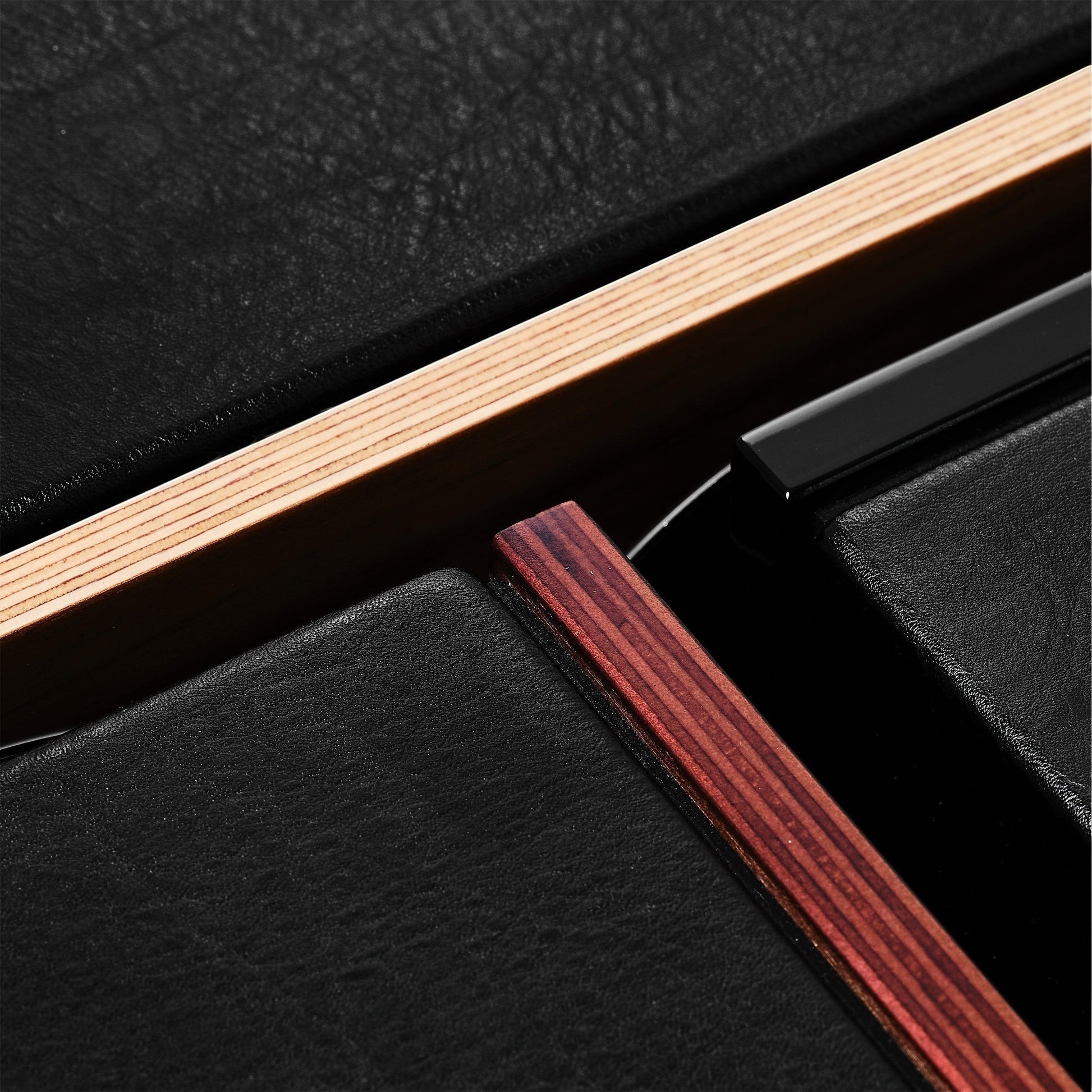 Salon 1 Audio Sonus faber Lumina speaker detail showing black leather texture, wood veneer, and layered cabinet edges.
