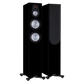 Salon 1 Audio Monitor Audio Silver 300 7G black floorstanding speakers with exposed drivers and one with grille on.