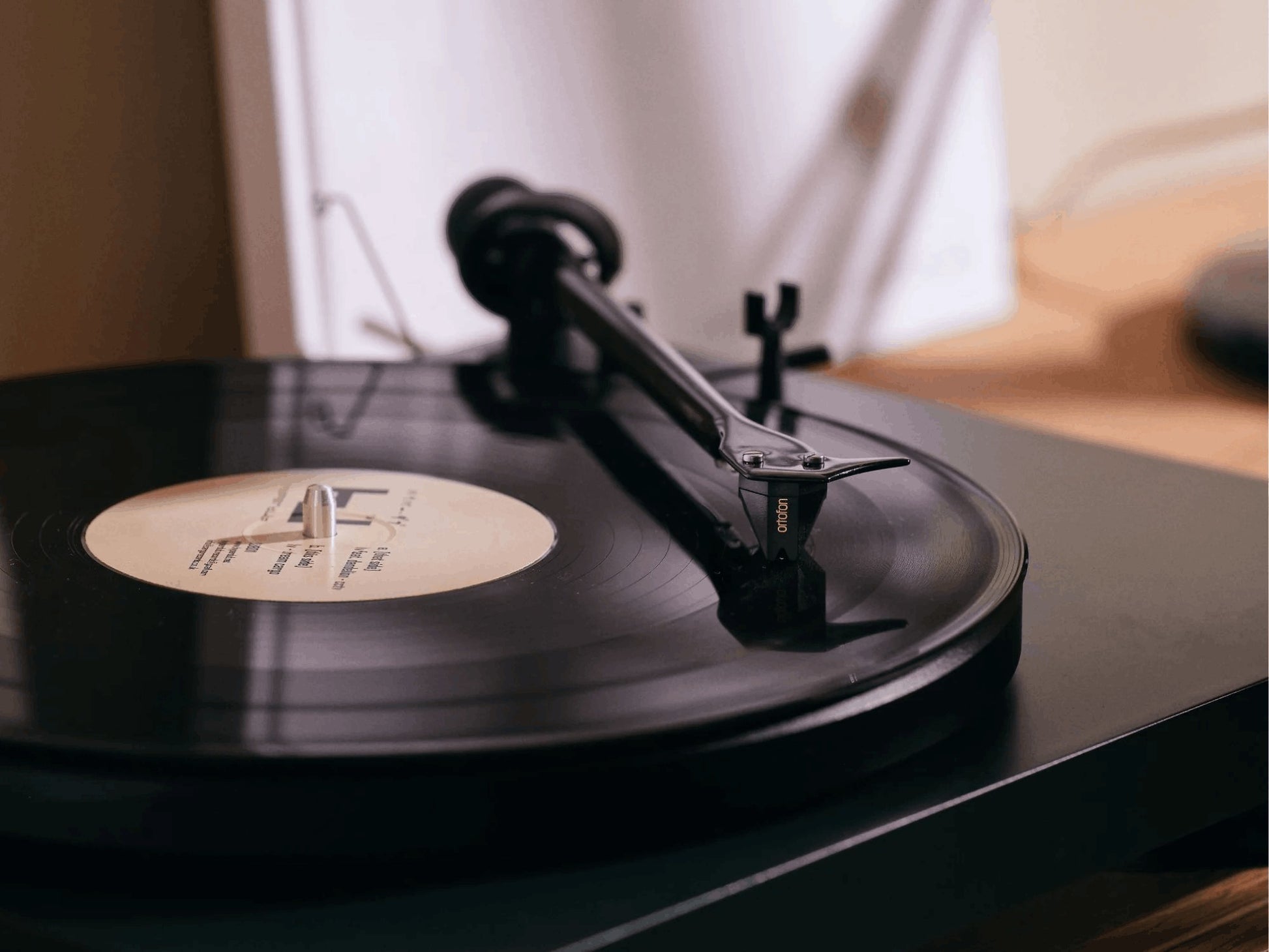 Salon 1 Audio Ortofon 2M Black moving magnet cartridge playing a vinyl record on a turntable tonearm