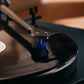 Salon 1 Audio Ortofon 2M Blue moving magnet cartridge with blue stylus playing a vinyl record on a turntable