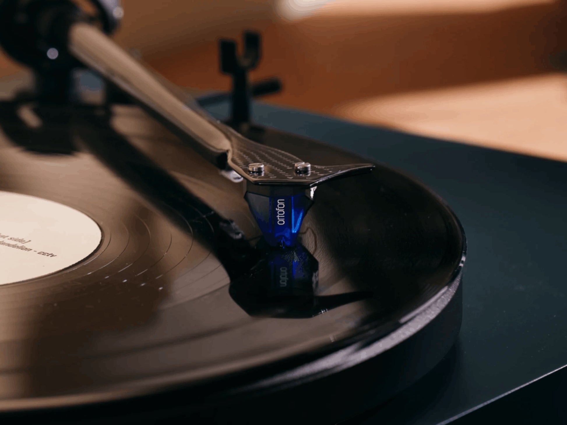 Salon 1 Audio Ortofon 2M Blue moving magnet cartridge with blue stylus playing a vinyl record on a turntable