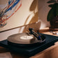 Salon 1 Audio Ortofon 2M Blue moving magnet cartridge installed on a turntable playing a vinyl record in a home setting