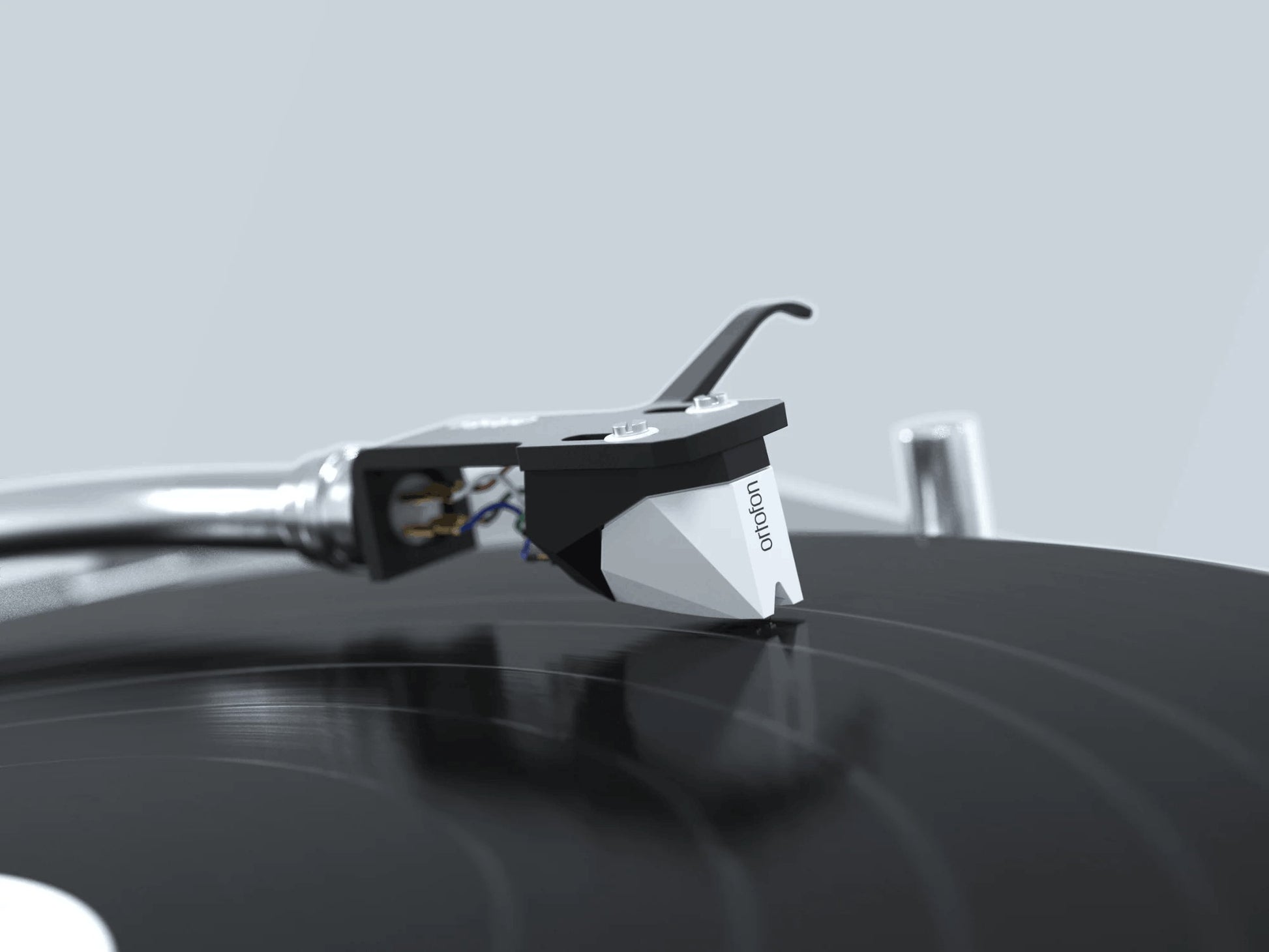 Salon 1 Audio Ortofon 2M Mono moving magnet cartridge with white and black body playing a black vinyl record