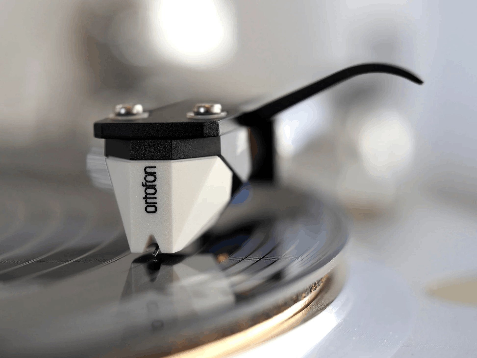 Salon 1 Audio Ortofon 2M Mono moving magnet cartridge with white and black body tracking on a vinyl record