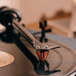 Salon 1 Audio Ortofon 2M Red moving magnet cartridge playing a black vinyl record on a turntable tonearm