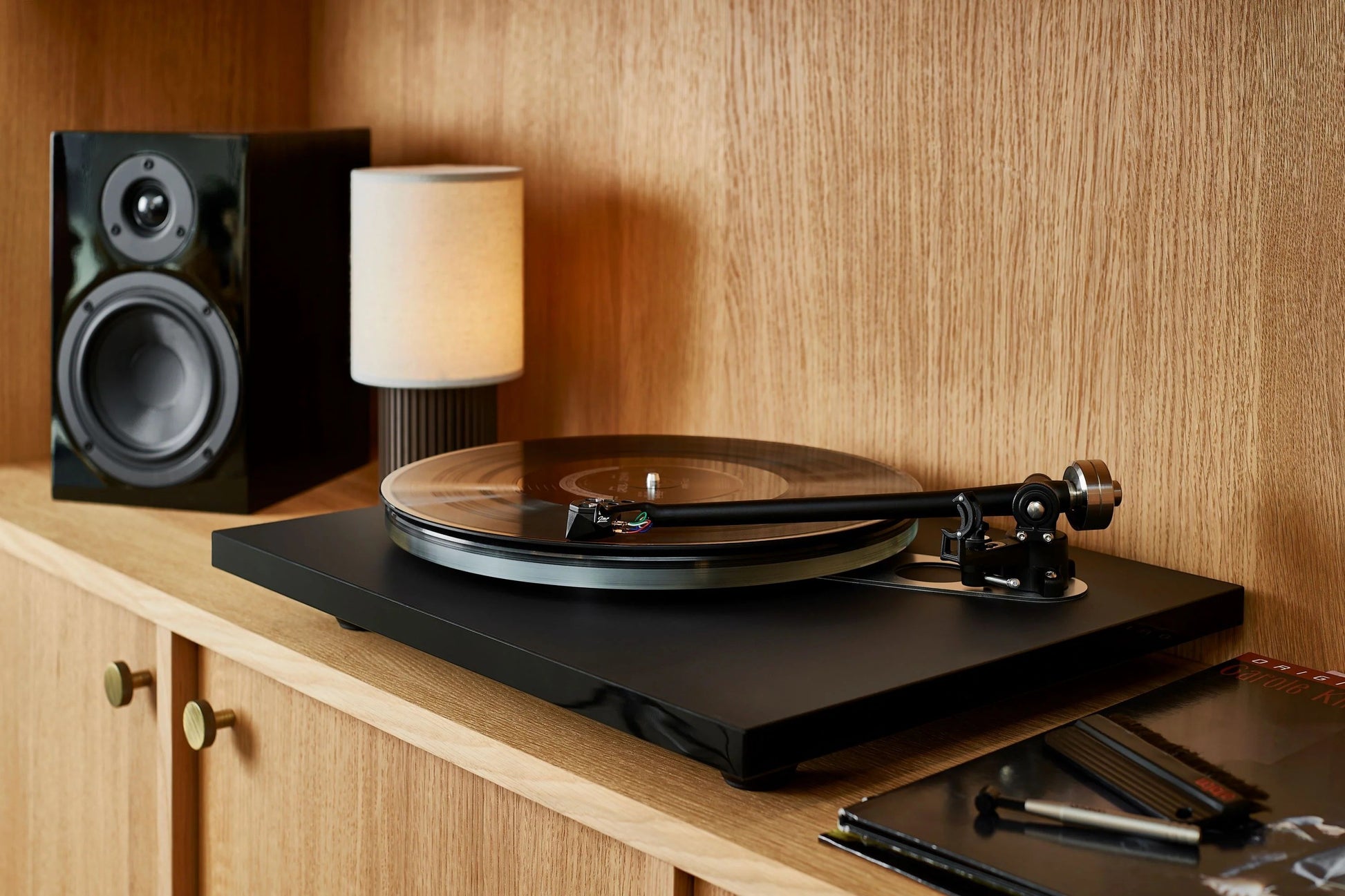 Salon 1 Audio Ortofon 2MR Black LVB 250 moving magnet cartridge installed on a turntable in a modern home setting.