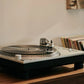 Salon 1 Audio Ortofon MC Cadenza Black phono cartridge playing a vinyl record on a turntable in a home setting