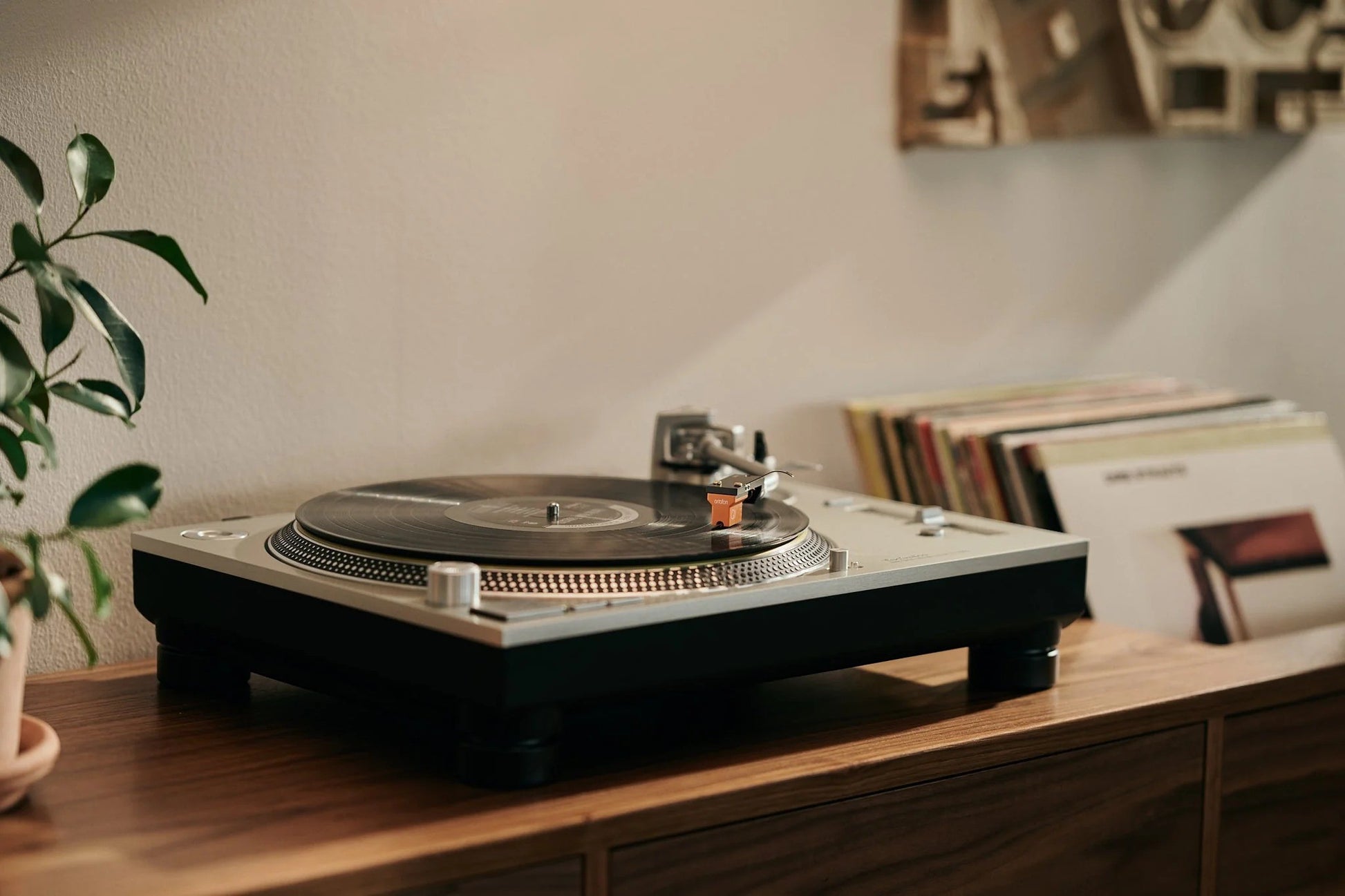 Salon 1 Audio Ortofon MC Quintet cartridge mounted on a silver turntable playing a vinyl record in a home setting