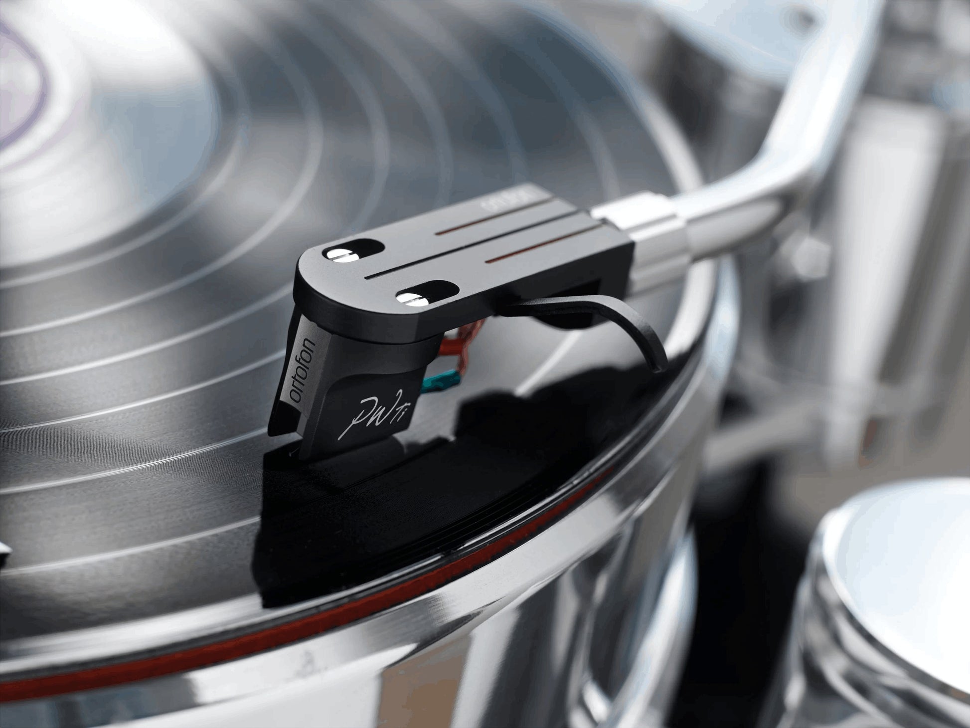 Salon 1 Audio Ortofon MC Windfeld Ti moving coil phono cartridge tracking a black vinyl record on a turntable.