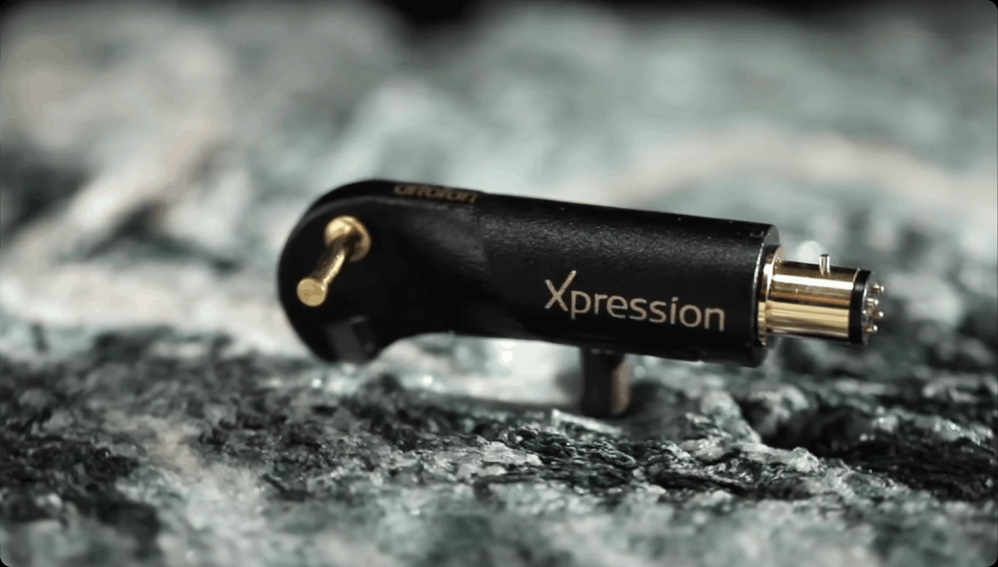 Salon 1 Audio Ortofon MC Xpression moving coil phono cartridge in black, resting on a textured stone surface.