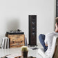 Salon 1 Audio Sonus faber Lumina III floorstanding speakers in a modern living room with a man listening to music.