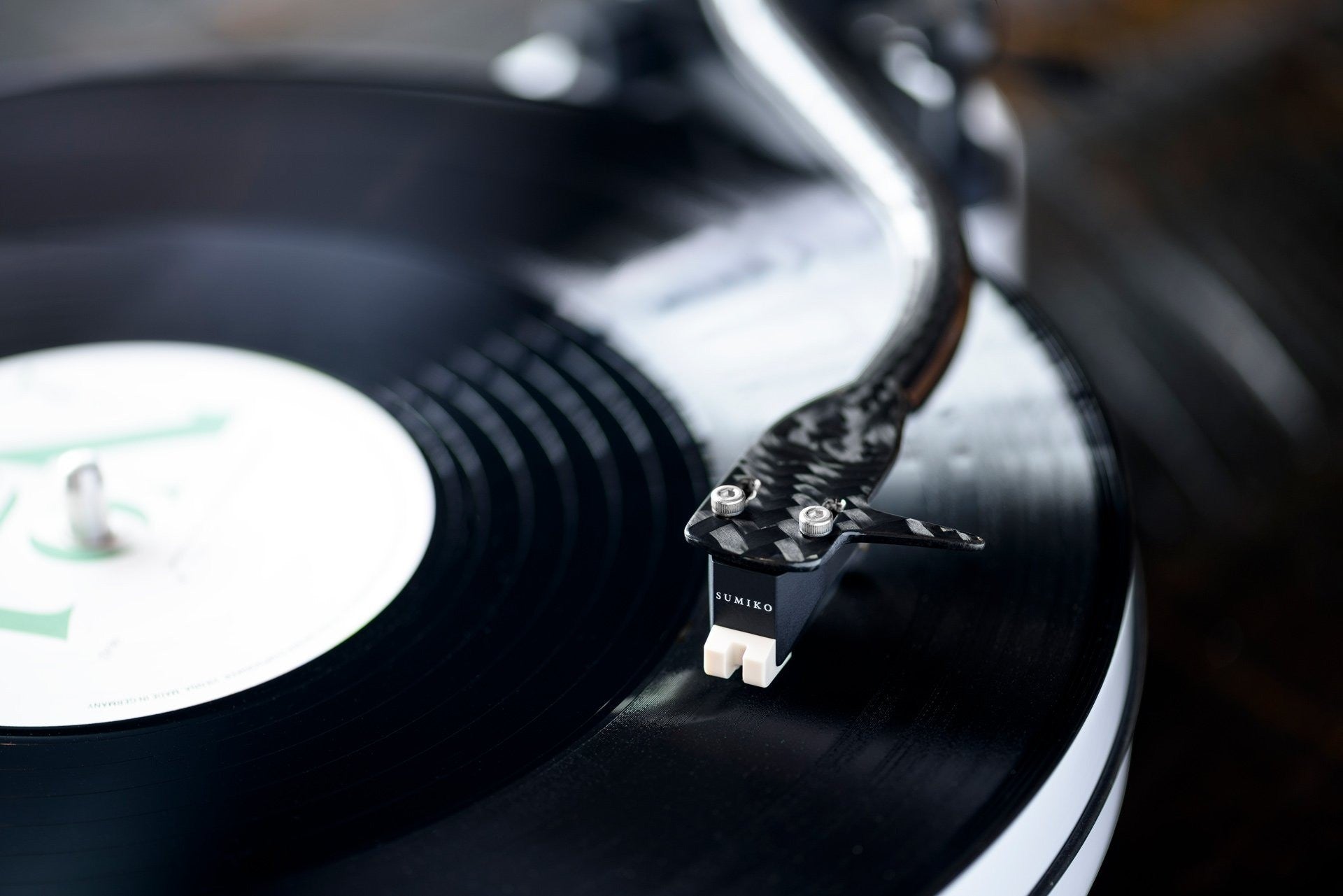Salon 1 Audio Sumiko Rainier moving magnet cartridge mounted on a carbon fiber tonearm playing a black vinyl record
