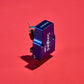 Salon 1 Audio Sumiko Songbird Low moving coil phono cartridge in blue with an open-body design on a red background.