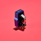 Salon 1 Audio Sumiko Songbird Low moving coil cartridge in blue with an open-body design on a vibrant red background.