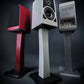 Salon 1 Audio Wilson Audio TuneTot bookshelf speakers in crimson, white, and gray finishes on dedicated stands.