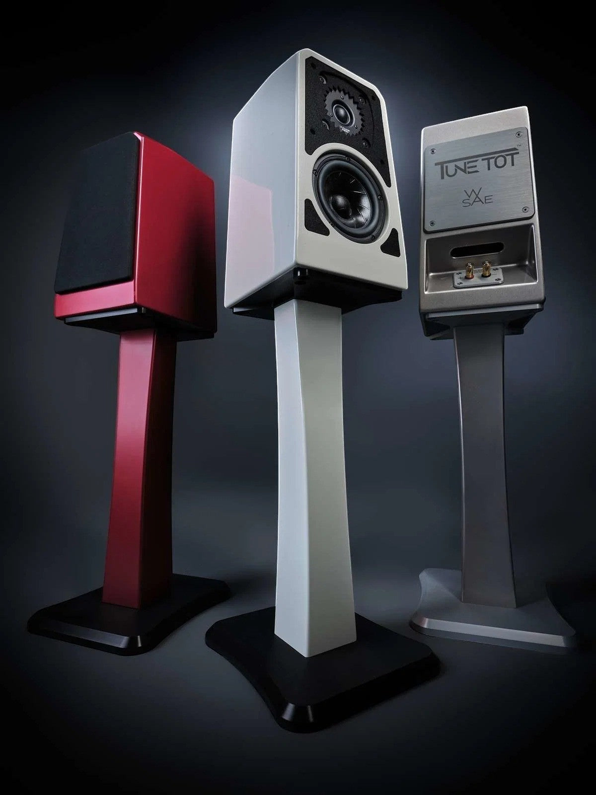 Salon 1 Audio Wilson Audio TuneTot bookshelf speakers in crimson, white, and gray finishes on dedicated stands.