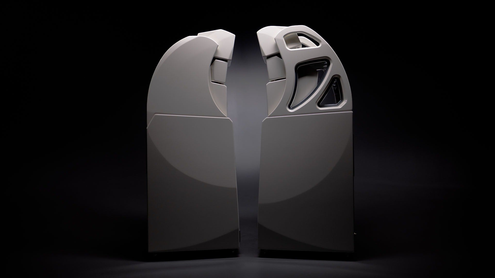Salon 1 Audio Wilson Audio Alexx V floorstanding speakers in a sleek light finish against a dark background.